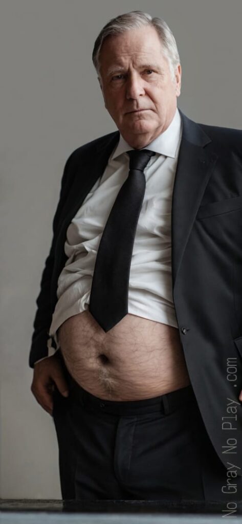 Grandpa in a suit shows pens